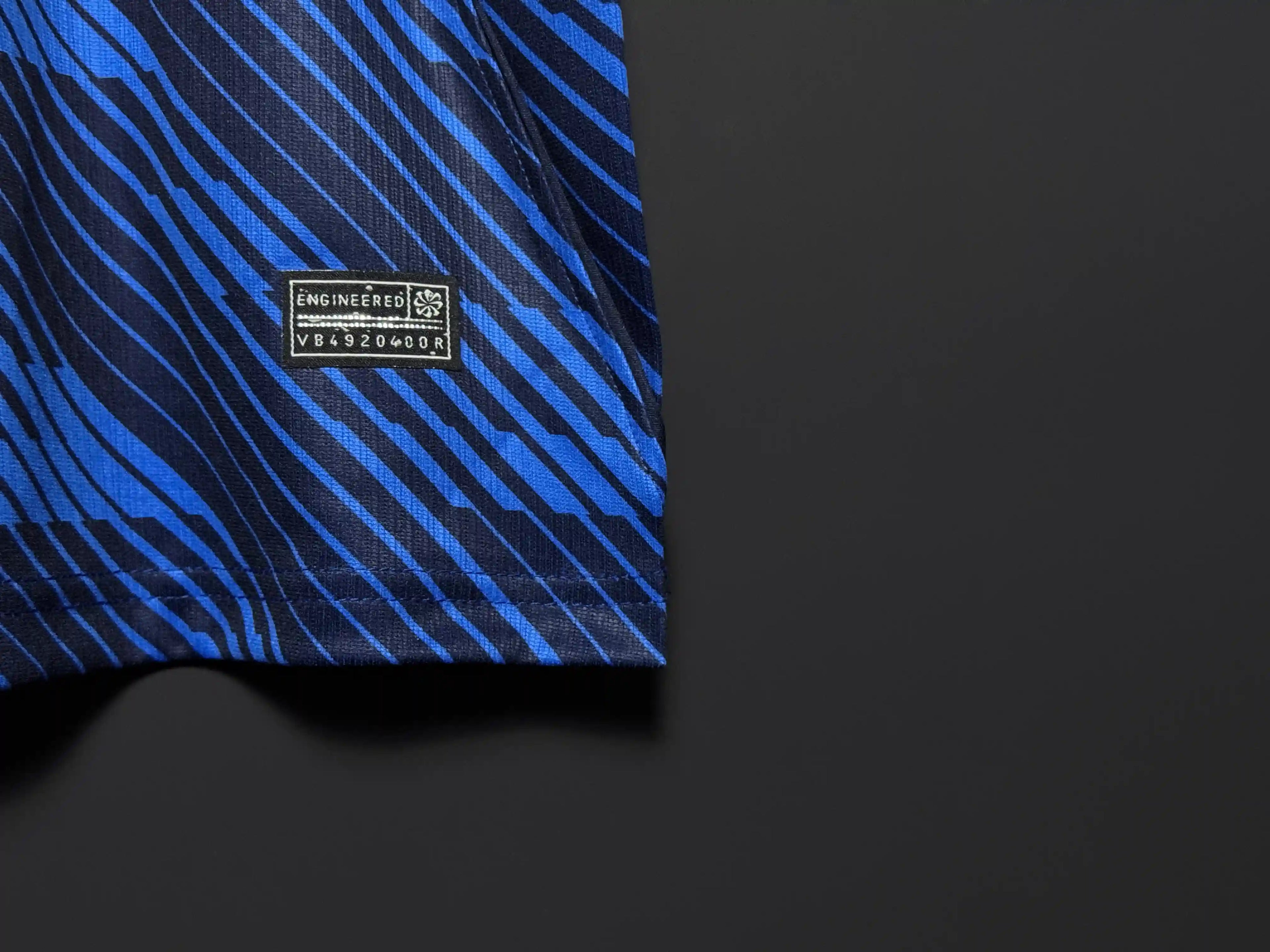 Blue and black striped fabric with a brand label