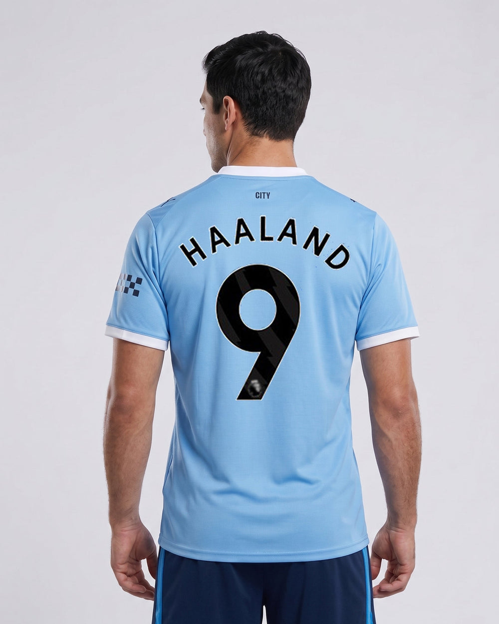 Person wearing a light blue sports jersey with 'Haaland 9' printed on the back, on a plain background.