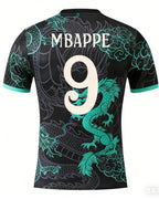 Black sports jersey with green dragon designs and 'MBAPPE 9' on a white background