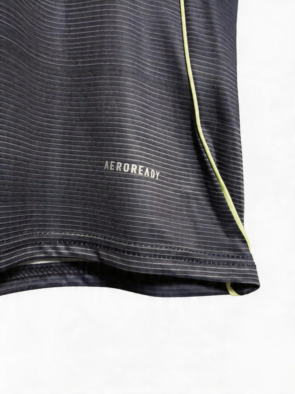 Close-up of a black athletic shirt with 'Aeroready' text on a white background