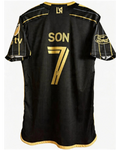 Black sports jersey with gold lettering and logos on a white background