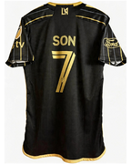 Black sports jersey with gold lettering and logos on a white background
